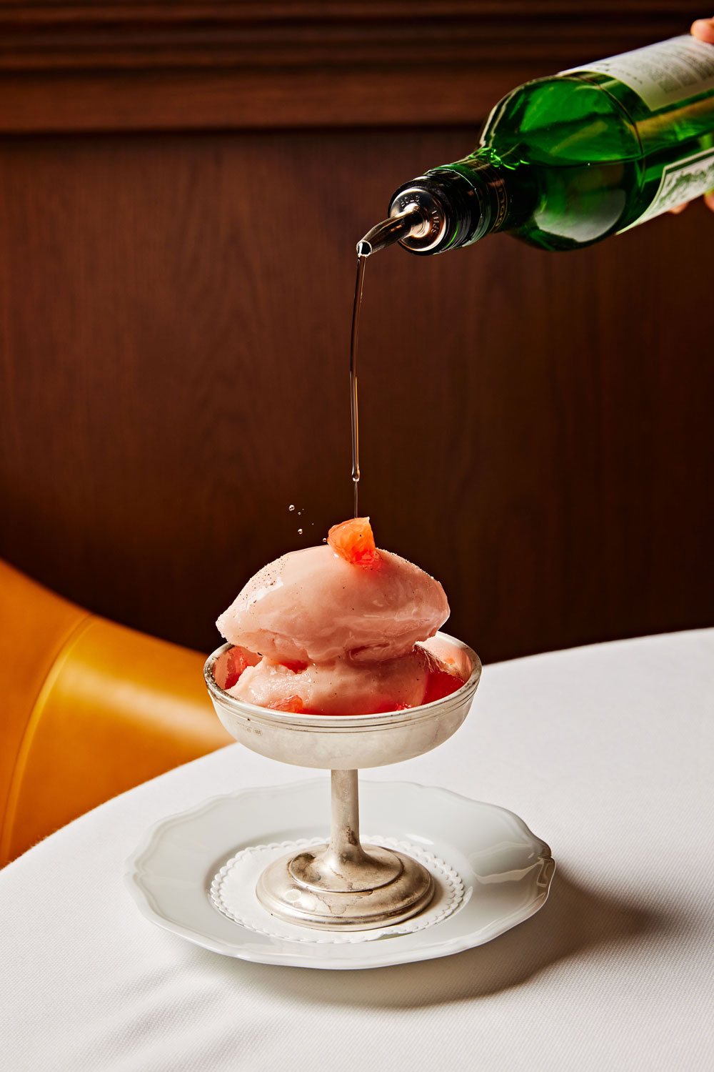 Grapefruit sorbet with dry vermouth being poured on top