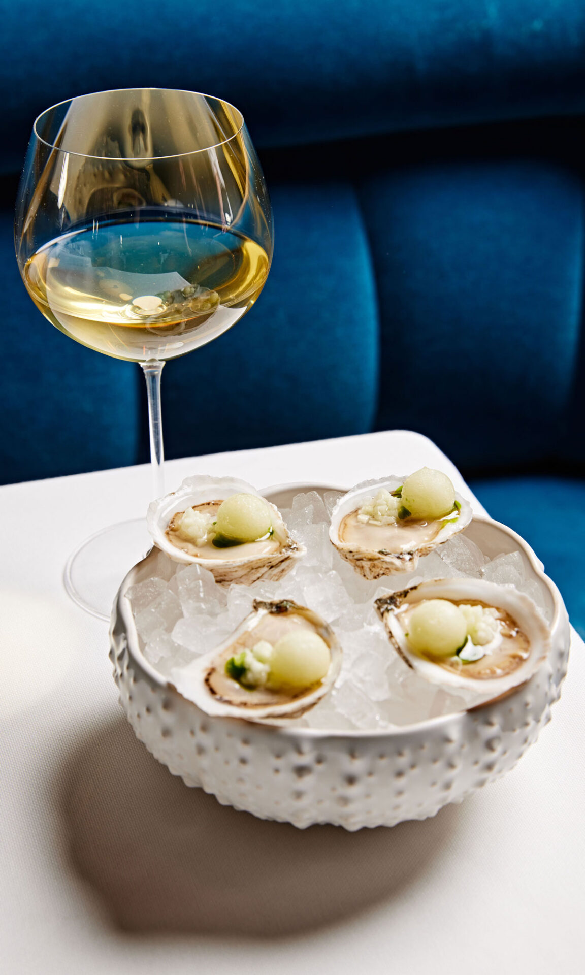 Oysters à la pomme are garnished with tart spheres of green apple sorbet