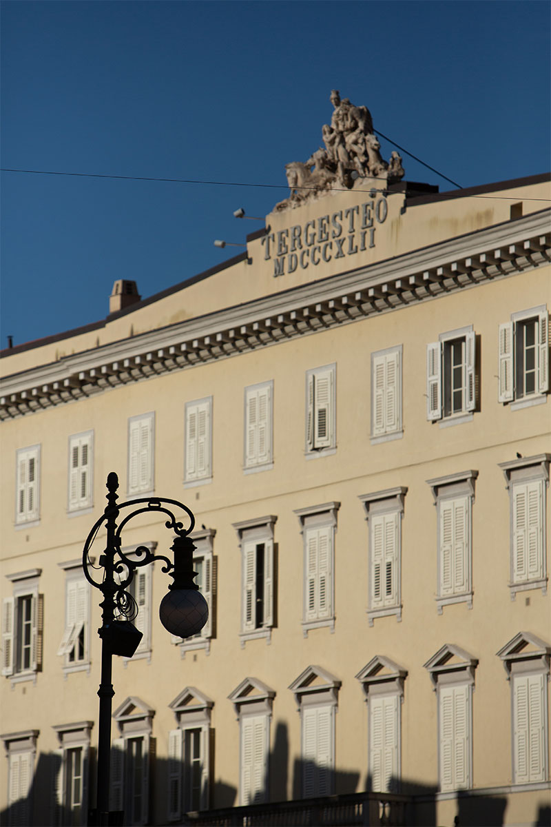 Architectural detail of Palazzo del Tergesteo, an elegant neoclassical building overlooking Piazza della Borsa and Piazza Verdi in Trieste.