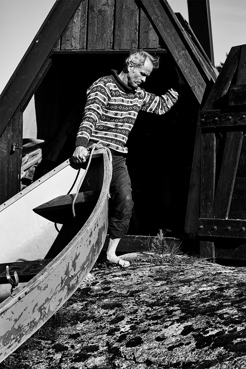 Kagge pulling his canoe into the shed near his cabin in the Blefjell region of Norway.